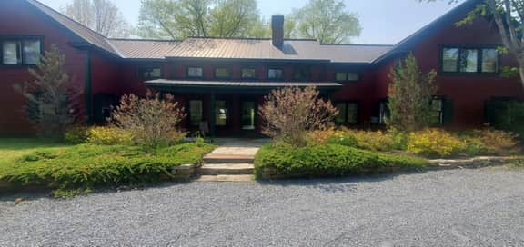 The Old Orchard Home surrounded by a small apple orchard, large meadows, and a private pond